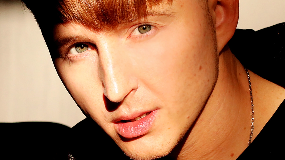 MKSM wearing a black shirt against a light background