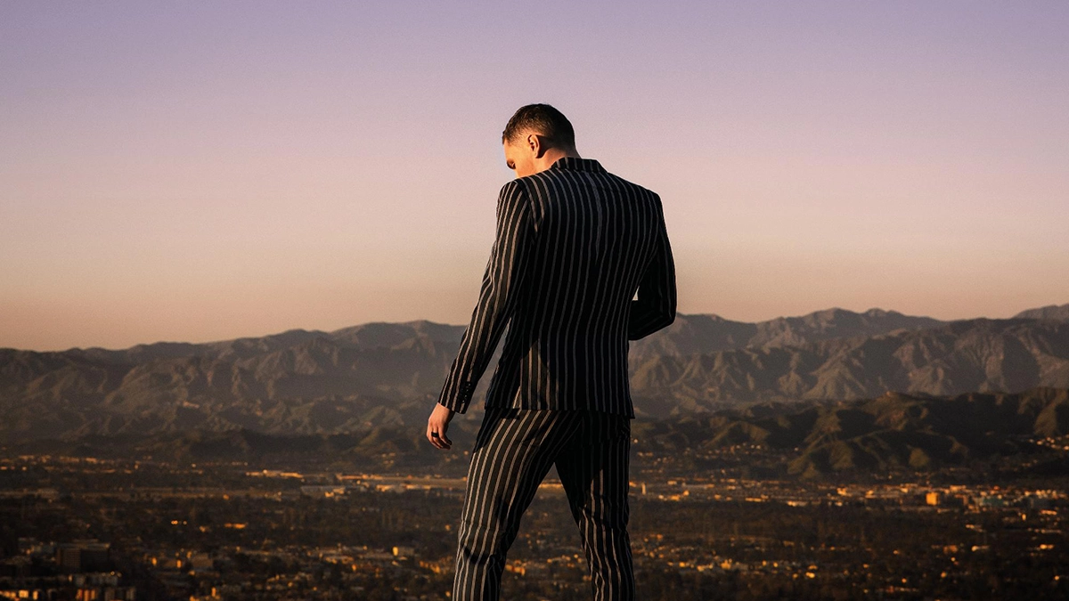Patrik Jean Prosecco - album cover - Patrik stands alone with his backside towords us and we can see mountain in front of him
