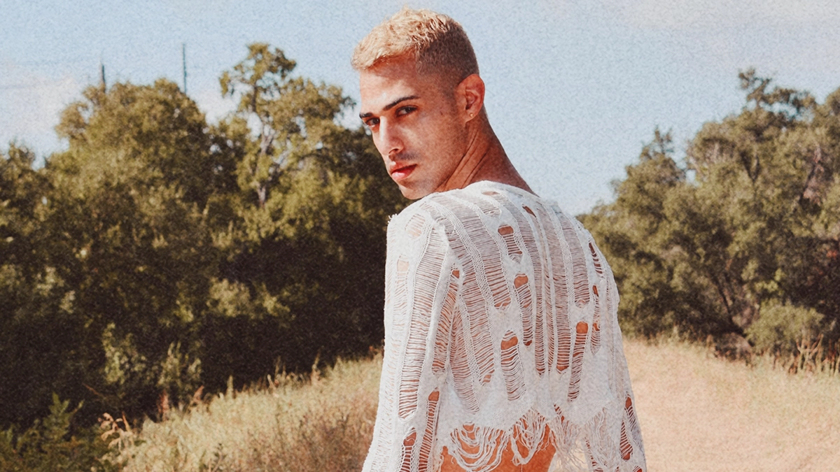 Picture of Jxckson with blond hair and whit nited see through shirt.