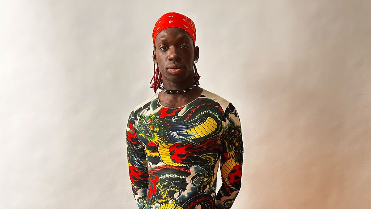 Saint Ahmad has red bandan, colourful shirt