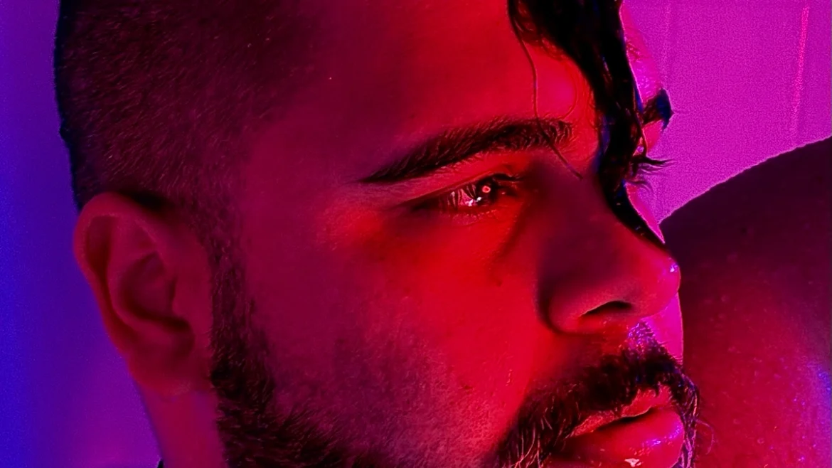 Close up of Ed Mvrtin with purple light in the background.