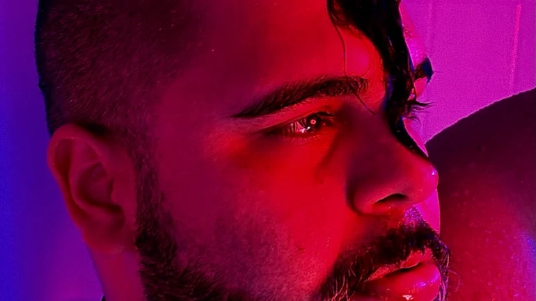 Close up of Ed Mvrtin with purple light in the background.
