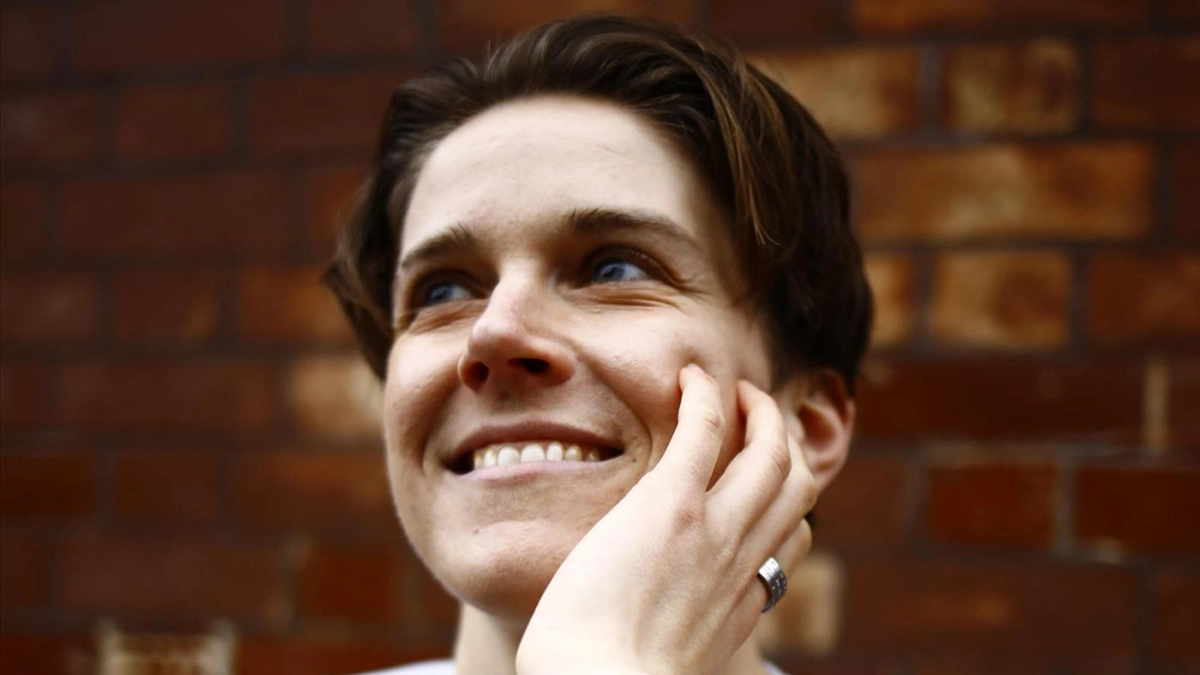 Heff VanSaint smiling in front of a brick wall.