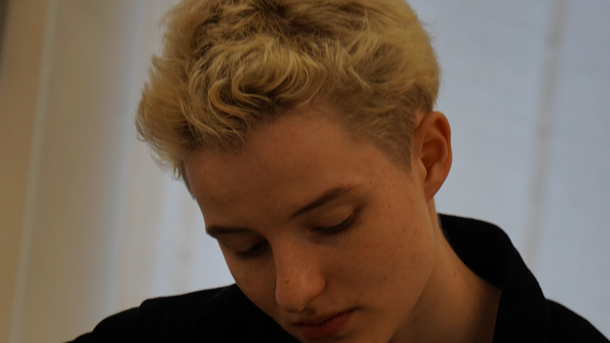 Noah Elliott blond hair,thye have a black shirt on.